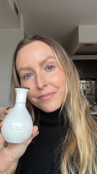 Sarah Kinonen holding bottle of The Harmonist Sacred Water